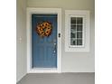 Welcoming front door with seasonal sunflower wreath at 7128 Summer Holly Pl, Riverview, FL 33578