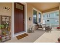 Inviting front porch with a wicker bench and decorative lanterns at 1407 7Th N Ave, St Petersburg, FL 33705