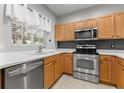 Modern kitchen with stainless steel appliances and light wood cabinets at 214 Cape Harbour Loop # 105, Bradenton, FL 34212