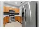 Modern kitchen with stainless steel appliances and wood cabinets at 214 Cape Harbour Loop # 105, Bradenton, FL 34212