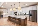 Modern kitchen with large island, stainless steel appliances, and ample counter space at 13716 Brookside Haven St, Riverview, FL 33578