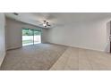 Bright living room with sliding glass doors and tile floors at 10467 Heron Hideaway Loop, Land O Lakes, FL 34638