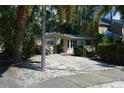 House exterior showcasing a teal-roofed home with a driveway and palm trees at 785 5Th S St, Safety Harbor, FL 34695