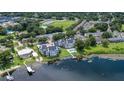Waterfront condo complex boasts a community pool and docks on a picturesque lake surrounded by lush greenery at 3127 W Sligh Ave # 204B, Tampa, FL 33614