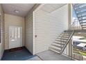 Condo entrance showing unit number, a welcome mat, and stairs at 3127 W Sligh Ave # 204B, Tampa, FL 33614