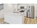 The kitchen features an island with quartz countertops and stainless steel appliances at 6240 Golden Beach Dr, Apollo Beach, FL 33572