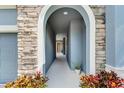 Stone arch entryway leading to the front door of the house at 6419 Blue Sail Ln, Apollo Beach, FL 33572