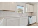 White kitchen with quartz countertops and hexagon backsplash at 6220 Golden Beach Dr, Apollo Beach, FL 33572