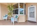 Inviting condo entrance with wicker chairs and plants at 6251 Shoreline Dr # 2102, St Petersburg, FL 33708