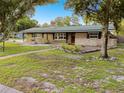 1-story home with mature trees and walkway at 1756 Ashton Abbey Rd, Clearwater, FL 33755