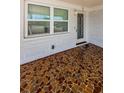 Covered porch with terracotta tile flooring at 1551 Derrick St, Holiday, FL 34690