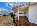 Covered porch with terracotta tile flooring at 1551 Derrick St, Holiday, FL 34690