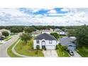 Two-story house with a gray roof, white exterior, and a landscaped yard at 2746 Heathgate Way, Land O Lakes, FL 34638