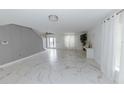 Spacious living room with marble floors and access to the kitchen at 2746 Heathgate Way, Land O Lakes, FL 34638