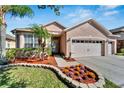 Two-story house with a two-car garage and landscaped yard at 31415 Bridgegate Dr, Wesley Chapel, FL 33545