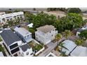 Aerial view showcasing a well-situated gray home with balconies and lush greenery, near a highway at 1408 W Azeele St, Tampa, FL 33606