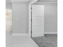 Modern interior door separating rooms with neutral colors and flooring at 701 Madison Sw St, Ruskin, FL 33570