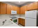 Bright kitchen with ample cabinetry, white appliances, and double sink at 7219 Hamilton Rd # 7219, Bradenton, FL 34209