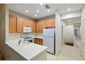 Modern kitchen with light wood cabinets and white appliances at 7219 Hamilton Rd # 7219, Bradenton, FL 34209