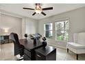 Bright home office with a large desk, comfortable chair, and natural light at 13573 Willow Bluestar Loop, Riverview, FL 33579