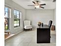 Home office featuring a desk, chair, and plenty of natural light at 13573 Willow Bluestar Loop, Riverview, FL 33579