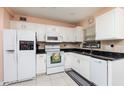 Bright kitchen with white cabinets, granite countertops, and stainless steel appliances at 3950 Arkansas Ne Ave, St Petersburg, FL 33703