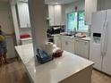 Updated kitchen with white cabinets and breakfast bar at 705 Skyview Ave, Clearwater, FL 33756