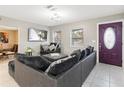 Spacious living room with sectional sofa and large TV at 1009 Cobblestone Dr, Spring Hill, FL 34606