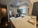 Modern kitchen with stainless steel appliances and breakfast bar at 100 4Th S Ave # 205, St Petersburg, FL 33701