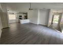 Open living room, kitchen, and dining area with gray floors at 13625 Laraway Dr, Riverview, FL 33579