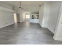 Bright living room with gray vinyl flooring and open kitchen at 13625 Laraway Dr, Riverview, FL 33579