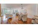 Bright dining area with hardwood floors and glass table, easily fits four chairs at 220 Belleview Blvd # 802, Belleair, FL 33756