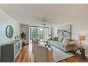 Living room features hardwood floors, neutral decor, and access to balcony at 220 Belleview Blvd # 802, Belleair, FL 33756