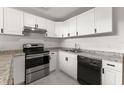 Modern kitchen with white cabinets, stainless steel appliances, and granite countertops at 12267 Armenia Gables Cir # 12267, Tampa, FL 33612
