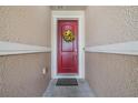 Red front door entrance with a sunflower wreath at 11537 Southern Creek Dr, Gibsonton, FL 33534