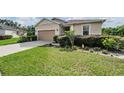House exterior with a well-maintained lawn and landscaping at 11537 Southern Creek Dr, Gibsonton, FL 33534
