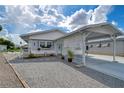 Single-story home with carport and landscaped yard at 4976 Britni Way, Zephyrhills, FL 33541