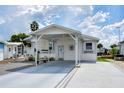 Single-story home with carport and landscaped yard at 4976 Britni Way, Zephyrhills, FL 33541