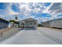 Single-story home with carport and landscaped yard at 4976 Britni Way, Zephyrhills, FL 33541