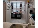 Cozy kitchen with white appliances and wood cabinets at 2351 Bentley Dr, Palm Harbor, FL 34684