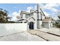 The house features a stylish exterior, complemented by a white fence and white rock landscaping at 6710 Myrna Dr, Tampa, FL 33619