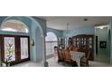 Bright dining room with a large wooden china cabinet and table set for a meal at 4467 Worthington Ct, Palm Harbor, FL 34685