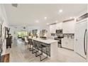 Modern kitchen with white cabinets, quartz countertops, and stainless steel appliances at 16664 Shell Bay Dr, Land O Lakes, FL 34638