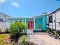 Bright teal home with walkway, landscaping, and RV parking at 4810 Chancellor Ne St, St Petersburg, FL 33703