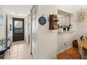 Bright condo entryway with tile flooring and view to dining area at 3399 Mermoor Dr # 207, Palm Harbor, FL 34685
