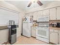 Condo kitchen with white appliances and ample counter space at 3399 Mermoor Dr # 207, Palm Harbor, FL 34685