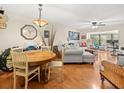 Living room with light gray sectional sofa and wood floors at 3399 Mermoor Dr # 207, Palm Harbor, FL 34685