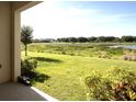 Spacious backyard with a tranquil view of a lake and lush greenery at 10823 Verawood Dr, Riverview, FL 33579