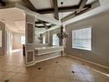 Elegant dining area with a coffered ceiling and tile floors at 12143 Maple Ridge Dr, Parrish, FL 34219