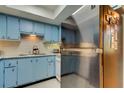 Stainless steel refrigerator and light blue cabinets in kitchen at 9537 86Th Ave # 9537, Seminole, FL 33777
